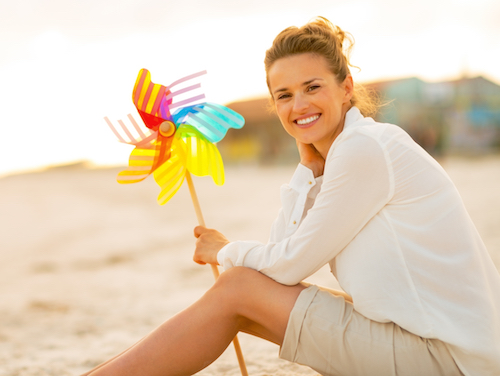 Woman on beach with pinwheel