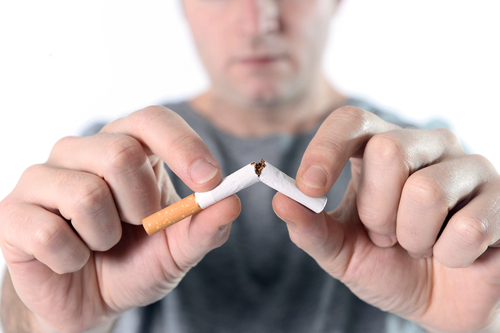 Guy breaking cigaretta in half