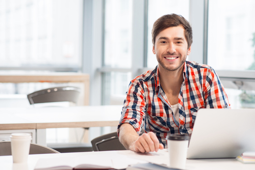 Man sitting at desk with laptop. 