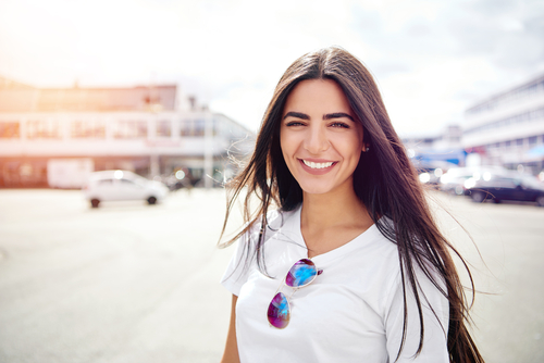 Lady wearing white shirt looking at camera. 