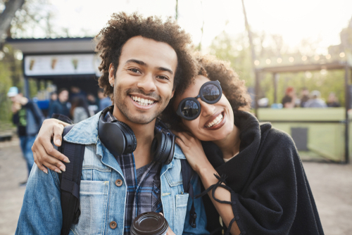 Couple looking into camera and smiling.