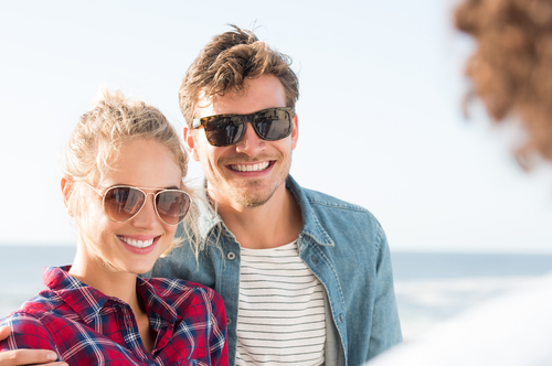 Young couple smiling outside after LASIK