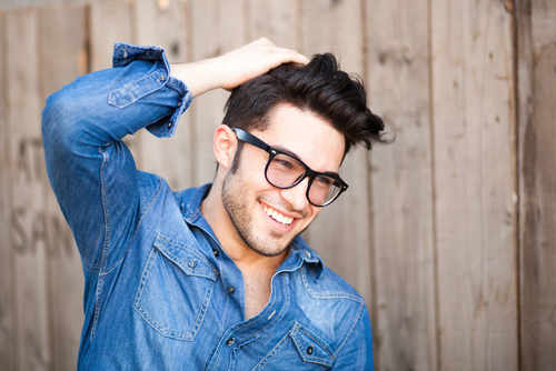 Young man with eyeglasses considering LASIK
