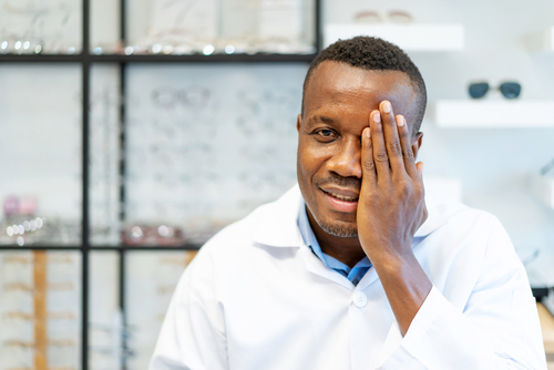 man covering his eye