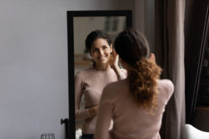 woman looking at herself in a mirror